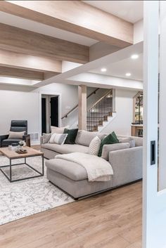 a living room with white walls and wood floors