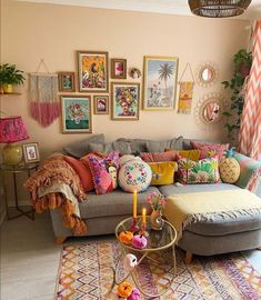 a living room filled with lots of furniture and pictures hanging on the wall above it