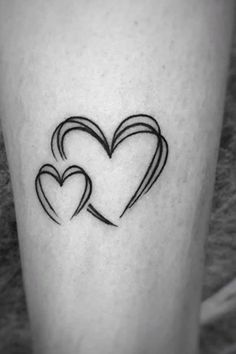 two hearts tattoo on the leg