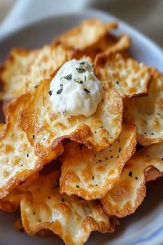 a white plate topped with cheesy potato chips