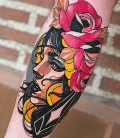 a woman's face with flowers on her head is shown in this tattoo design