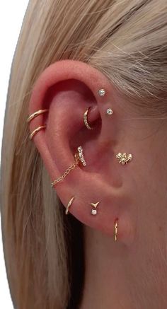 a woman's ear with three different types of piercings