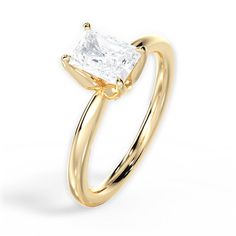 a gold ring with a princess cut diamond in the center, on a white background