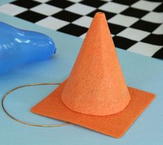 an orange cone sitting on top of a blue table