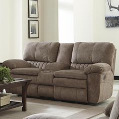 a living room scene with focus on the couch and reclining chair in the center