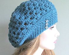 a mannequin head wearing a blue crocheted hat