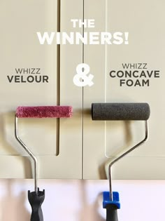 two paint rollers are hanging on the wall next to each other and one is holding a sponge