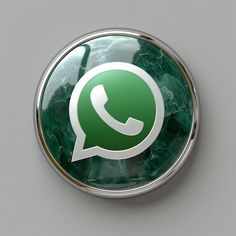 a green whatsapp button sitting on top of a wall