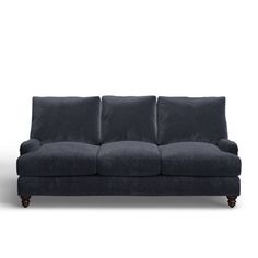 a black couch sitting on top of a white floor