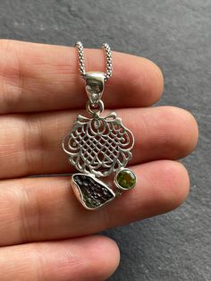 "Natural handcrafted Genuine Moldavite and natural Peridot pendant in 925 sterling silver. The total pendant height is 1.42\" in height(including the bail). You can also purchase high quality 925 solid silver Italian popcorn chain that is 1.8 mm thick and with anti-tarnish finish. The chain is made in Italy and 925 stamped. ✓You purchase comes in the gift box ✓ Natural Genuine Moldavite ✓ Solid 925 Sterling Silver (925 parts per 1000) ✓ 925 Silver Hallmarked ✓ Every natural stone is different an Handmade Silver Peridot Necklaces, Handmade Silver Peridot Necklace, Handmade Silver Necklace With Peridot, Silver Pendant Necklace With Peridot, Italian Popcorn, Crystal Structure, Peridot Pendant, High Vibrational, Tourmaline Pendant