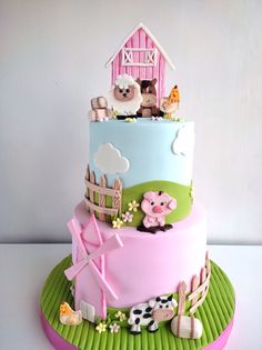 a three tiered cake decorated with farm animals