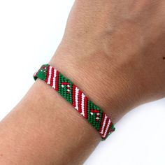 Let celebrate love and joy in Christmas time with this cute candy cane friendship bracelet! Red, green and white are perfect colors for Christmas!  Great idea for gift for someone special for you.  All my bracelets are made in smoke-free and pet-free environment. SIZE: Lenght (pattern part): 15 cm (5.9 inches) Width: 0.8 cm(0.31 inches) **Please take note: the colors of the product may vary due to different screen representations of the online photos.  Looking for that bracelet but in another co Red Casual Wristband As Gift, Casual Red Wristband For Gift, Casual Red Wristband As Gift, Christmas Friendship Adjustable Bracelets, Adjustable Christmas Friendship Bracelets, Red Beaded Bracelets For Christmas Gifts, Green Bracelets For Christmas Gift, Green Beaded Bracelets For Holiday Gifts, Handmade Green Bracelets For Holiday