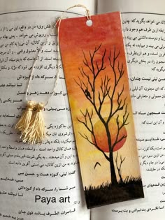 a bookmark with an image of a tree on it and the words paya art written in arabic