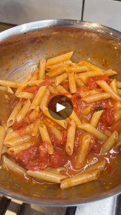 a pan filled with pasta and sauce on top of a stove