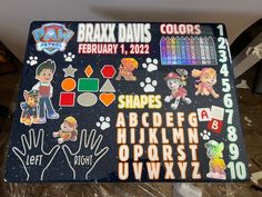 a sign with stickers on it that says brax davis colors, shapes and alphabets