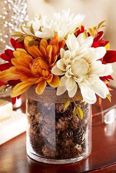 a vase filled with flowers sitting on top of a table