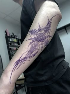 a man with a purple tattoo on his arm