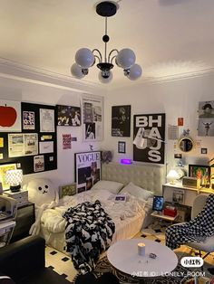 a bedroom with pictures on the wall and a chandelier hanging from the ceiling