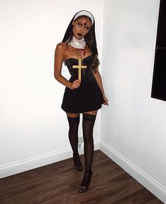 a woman dressed up as a nun with a cross on her chest and black stockings