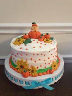 a baby shower cake with sunflowers and pumpkins on the top is being viewed on instagram