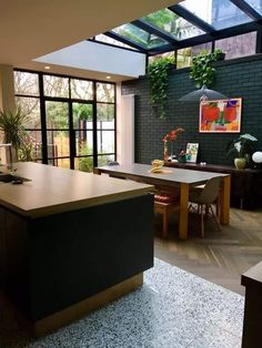 an open kitchen and dining room with large windows