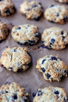 blueberry oatmeal cookies sitting on top of a baking sheet lined with parchment paper