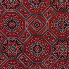 a red and blue area rug with an intricate design on the center, surrounded by smaller geometric shapes