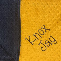 a yellow and black towel with the word yoy yag written on it