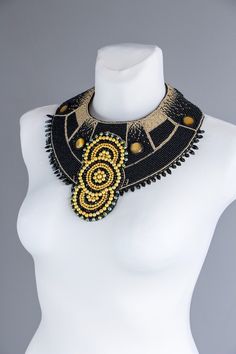 Extra large statement black Cleopatra beaded necklace. Original Egypt jewelry piece. Black necklace with gold universe ornaments. Unique and one of a kind beaded jewelry design by Rasaviljewelry. I have used gold and black 10 and 9 size beads. Metal buckle in the middle, black felt, welshman 0.18 mm, black. Green Czech glass, yellow- gold glass beads, natural black leather on the back side. It could be made with faux - vegan leather, please leave the note under the order. NECKLACE WILL BE MADE J Adjustable Gold Beads, Gems, And Cabochons, Gold Beaded Round Choker, Gold Beaded Chain Necklace For Festival, Party Large Beads Round Beaded Necklaces, Gold Round Beaded Necklaces, Gold Bib Necklace With Colorful Beads, Elegant Gold Choker With Colorful Beads, Gold Beaded Necklaces With Black Beads For Festivals, Beaded Costume Jewelry Necklaces