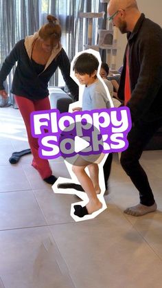 two adults and a child standing in front of a couch with the words floppy socks on it