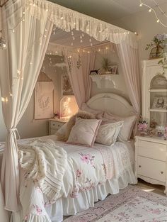 a white bed sitting in a bedroom next to a dresser and window covered with curtains