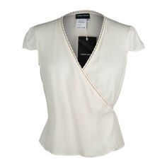 Guaranteed authentic Giorgio Armani Black Label elegant and chic wrap top. Simple in winter white silk. V neckline with the wrap 'tie' going through loops along the edge of the top.A small cap sleeve.NEW or NEVER WORN. Price tag of $875.00 attached.Please check measurements - runs small.final saleSIZE 44 USA SIZE 8TOP MEASURES: LENGTH 19"UNDERARM TO UNDERARM 18"WAIST 16.25" CONDITION:NEW or NEVER WORN Elegant Wrap Blouse For Formal Occasions, Formal Fitted Wrap Top, Elegant Summer Wrap Top For Work, Elegant Wrap Top For Spring, Elegant Wrap Top For Workwear, White Fitted Elegant Wrap Top, Elegant Wrap Top For Work, Elegant Formal Wrap Top, Elegant Fitted White Wrap Top