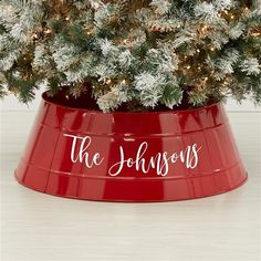 a christmas tree in a red bucket with the words, the johnsons on it