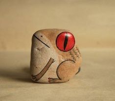 a rock with a bird painted on it