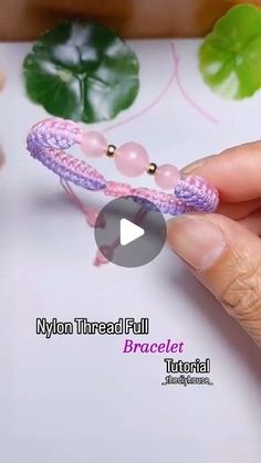 a person is holding a pink bracelet with beads on it's end and the words nylon threaded full braccial