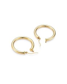 Simply chic, these 14K. yellow gold hoops are timeless classics. Classic Gold-tone Round Huggie Earrings, Yellow Gold Hoop Earrings With Shiny Finish, Yellow Gold Shiny Hoop Earrings Fine Jewelry, Timeless Yellow Gold Hoop Earrings With Shiny Finish, Classic Gold-tone Tarnish Resistant Hoop Earrings, Luxury 14k Yellow Gold Hoop Earrings, Timeless Yellow Gold Hoop Earrings For Anniversary, Formal Fine Jewelry Yellow Gold Hoop Earrings, Formal Yellow Gold Hoop Earrings