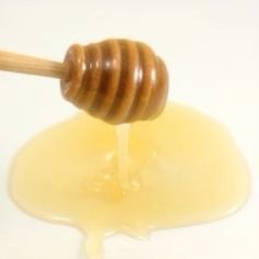 a honey dip with a wooden stick sticking out of it