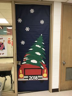 a door decorated with a christmas tree and firetruck