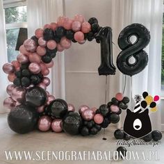 the balloon arch is decorated with black, pink and white balloons in the shape of numbers