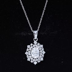 a white diamond pendant on a black background