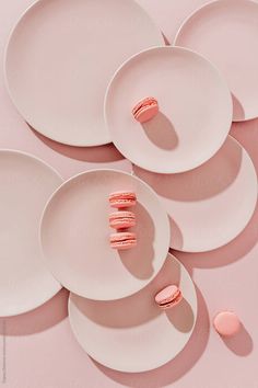 pink and white plates stacked on top of each other