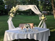 a table set up for a wedding with flowers on it