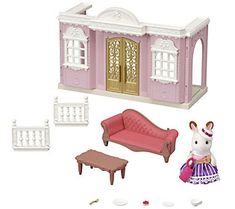 a doll house with furniture and accessories including a couch