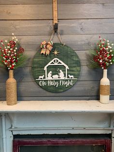 three christmas decorations sit on top of a fireplace mantel