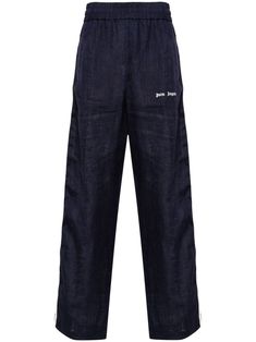 Blue linen sports trousers with elastic waistband and wide leg, ecru side bands with black thread. Vertical pockets and contrasting embroidered Palm Angels monogram. Men Logo, Logo Pants, Linen Joggers, Logo Azul, Angel Outfit, Angels Logo, Water Consumption, Navy Linen, Sports Trousers