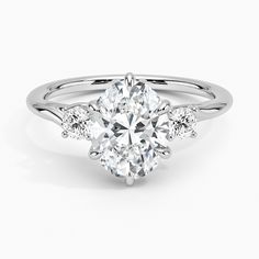 an oval cut engagement ring with side stones