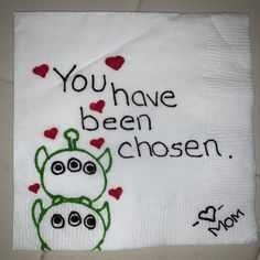 a napkin with embroidered words on it that says you have been chosen and two little monsters