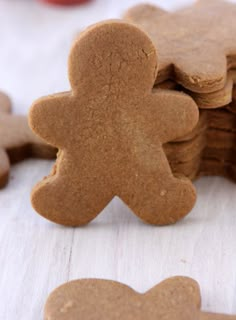 several cookies shaped like people sitting next to each other on top of a white table