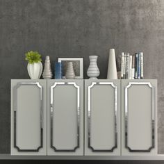 a white cabinet with three mirrors and vases on the top, next to a gray wall