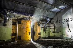 two yellow doors are open in an abandoned building